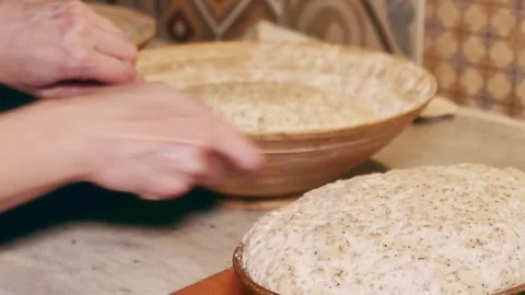 Home-made bread dough being put into ceramic forms Stock Footage 280266210