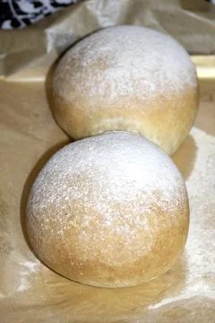 Home made bread roll baps freshly cooked with flour sprinkled on top Stock Photos