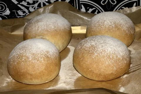 Home made bread roll baps freshly cooked with flour sprinkled on top Foto stock