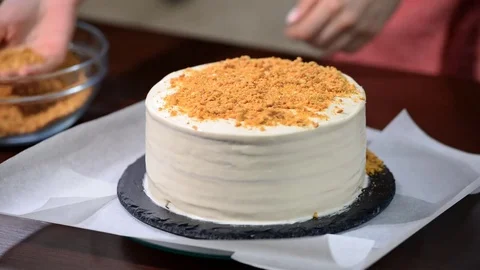 Home made cake with sprinkling. The Baker sprinkles the crumbs on cake. Stock Footage