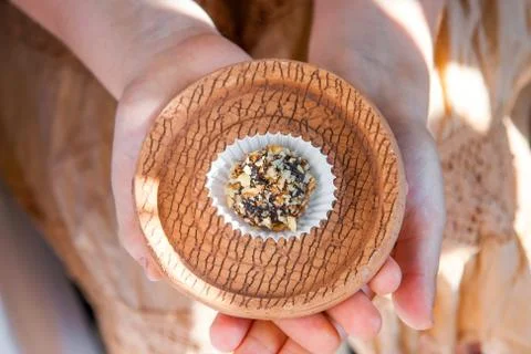Home made candy with walnut and date on bronw clay plate Stock Photos