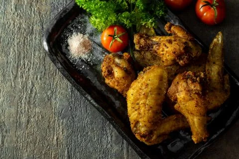 Home made, free range and organic coconut oil fried chicken wings. Stock Photos