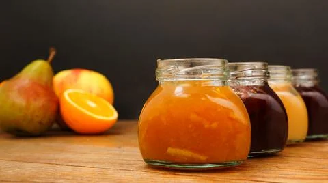 Home-made jam, selective focus. Jars with marmalade, confiture. Sweet dessert Stock Photos