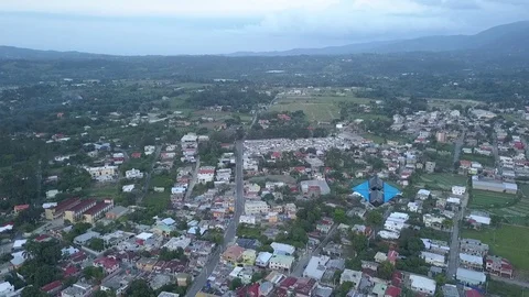 Home made kite flying high above urban landscape of jarabacoa dominican republic Stock Footage 129169917