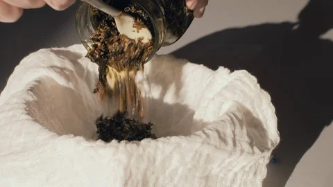 Home made ointment creating process. Herbs in oil being put on cloth in ball. Stock Footage 127720941