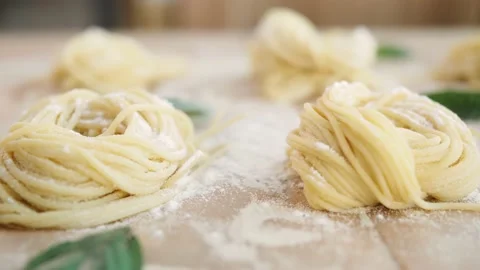 Home made pasta on the table with flour. Fresh pasta with wheat flour. Penne Stock Footage 143962840