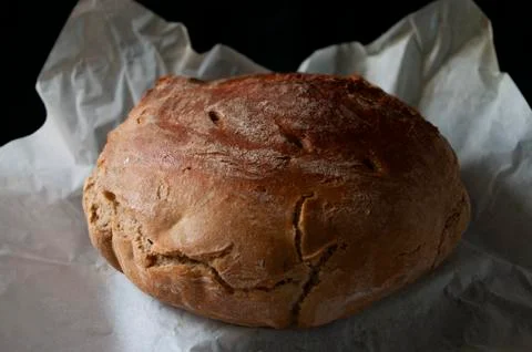 Home made sourdough bread on baking paper. Organic food. Whole grain rye flour. Foto stock