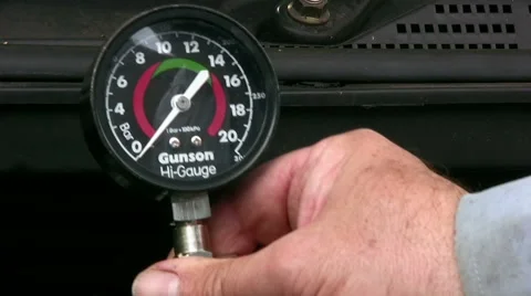 Home mechanic using vacuum gauge to show low engine cylinder compression test Stock Footage 59169671