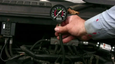 Home mechanic using vacuum gauge to show low engine cylinder compression test Stock Footage 59169852