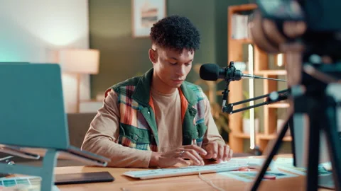 Home, mic and man with computer, typing and planning for talk show, broadcast Stock Footage 310461989