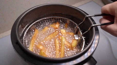 Home mini deep fryer get a basket of fries. Stock Footage 127150353
