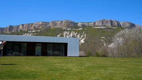 At home in the mountains. Middle-aged man somersaulting on the grass. 스톡 동영상 129559544