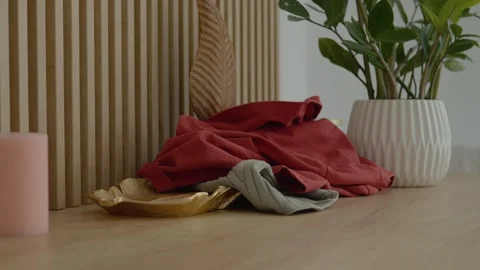 Home office clutter with clothes and decor creating a casual atmosphere Stock Footage 322111903