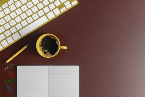 Home office desk with notebook, yellow pen, yellow keyboard and yellow cup of Stock Photos