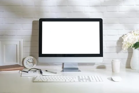 Home office interior with blank computer monitor and office supplies on whi.. Stock Photos