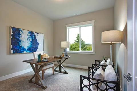 Home office interior in a new construction home. Wood x based desk paired wit Stock Photos