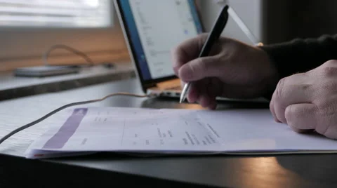 Home office, man going through and checking invoices/economy Vídeos de archivo 57239094