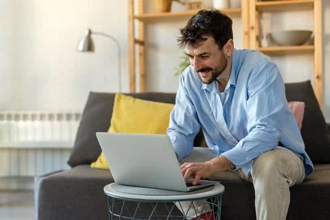 Home office. One smiling man using laptop. Work, freelance, social media, t.. 스톡 사진