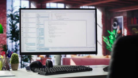 Home office with PC running terminal window for programming code Stock Footage 307795337