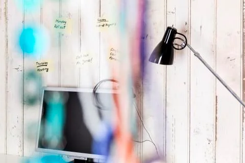 Home office with personal computer, headset and sticky notes on the wall Foto stock