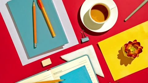 In the home office on a red table a notebook a pen a pencil and a cup of coffee. Stock Footage 220601108