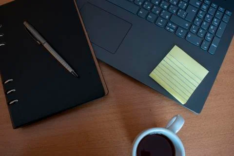 Home office setup,  during self-isolation. Keyboard, notebook, pen, coffee, n Stock Photos