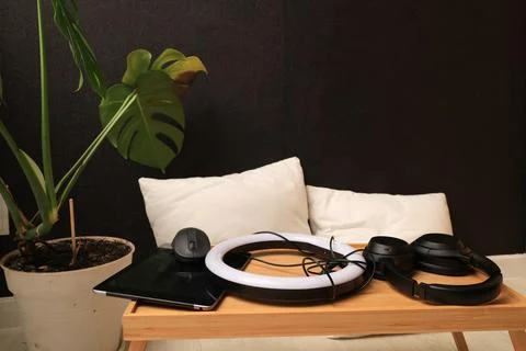 Home office setup with ring light, tablet, headphones, and plant on a tray Stock Photos