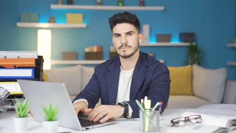 Home office worker looking dull at camera during work. Stock-Footage 237071362