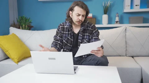 Home office worker looks at the document and gets angry. Stock Footage 236337196