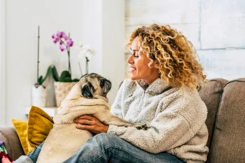 Home pet therapy dog and owner - happy caucasian woman have fun ith their lov Stock Photos