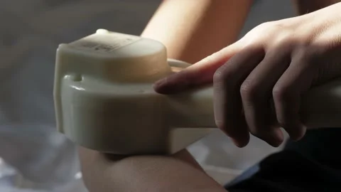 At-home physical therapy process . Current treatment device. Video stock 233233183