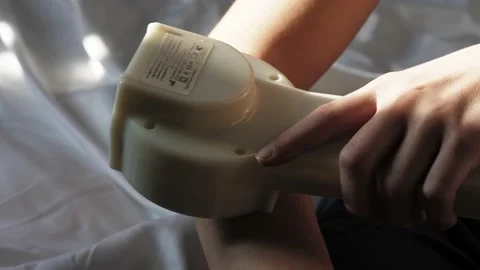 At-home physical therapy process . Current treatment device. Video stock 233233198