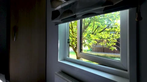 Home Radiator Below Open Window Looking Out to Green Garden Tree Stock Footage 340911883