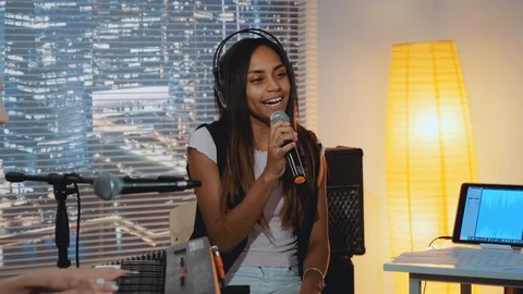 Home recording studio: multiracial pretty vocalist singing song into microphone Stock Footage 119266802