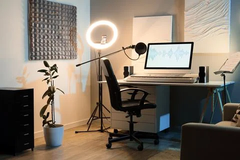 Home recording studio setup with computer screen displaying audio waveform, m Stock Photos