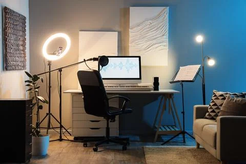 Home recording studio setup with microphone, computer monitor displaying soun Stock Photos
