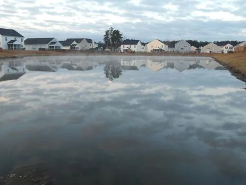 Home Reflections off a pond Stock Photos