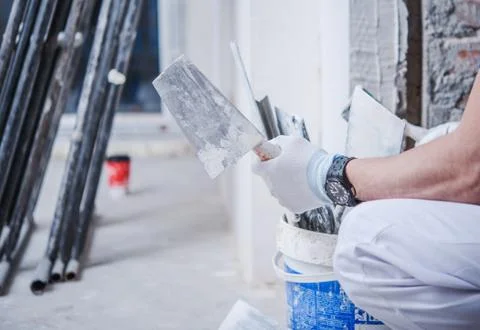 Home Remodeling Concept. Caucasian Worker with Construction Tools Stock Photos