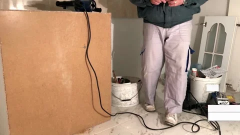 Home Renovation Process – Carpenter Working on Kitchen Cabinets Installation Stock Footage 303528805