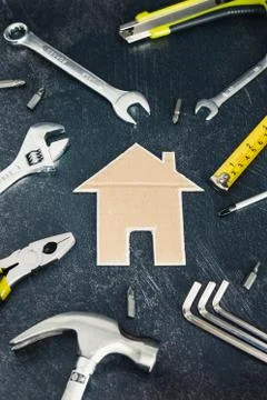 Home renovation set of DIY tools and little cardboard house Stock Photos