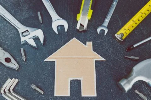 Home renovation set of DIY tools and little cardboard house Stock Photos