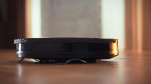 A home robot vacuum cleaner navigates and cleans residential floors using ad Stock Footage 331309150