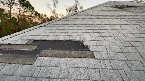 Home roof wind hurricane storm damage torn off missing shingles repair Stock Footage 217776853