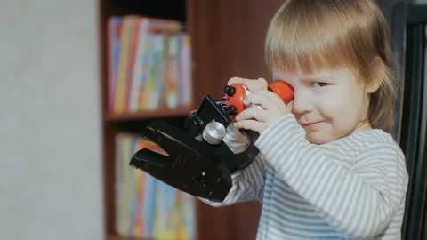 Home Science Tool Kids Microscope. Child development. Toddler playing with a Stock Footage 151161071