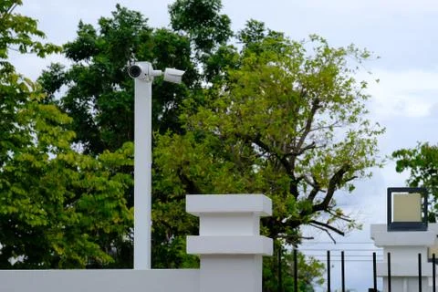 Home security CCTV camera surveillance system on the white metal pillar Stock Photos