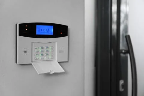 Home security system on white wall indoors, space for text Stock Photos