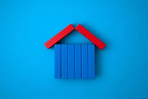 A home-shaped pattern made of colored dominoes. Stock Photos