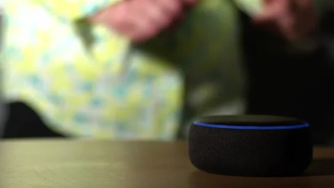 Home smart voice device in home with woman dancing in background Stock Footage 237622703