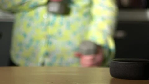 Home smart voice device in home with woman dancing in background Stock Footage 239463770