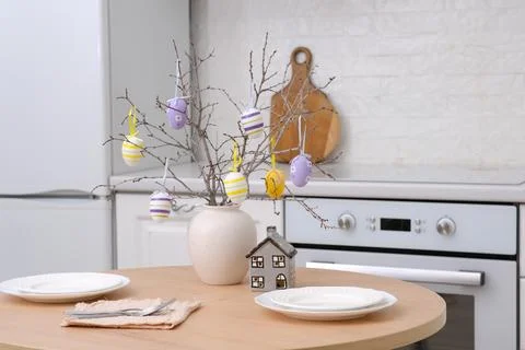 Home spring easter design in kitchen. Ceramic vase with spring branches with Stock Photos